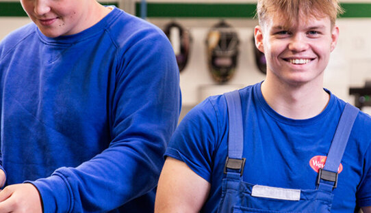 Picture of apprentices working at their workshop benches fixing a motor at Wewalka